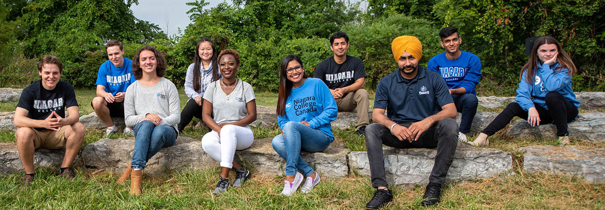Niagara College Students Sitting Outdoors.