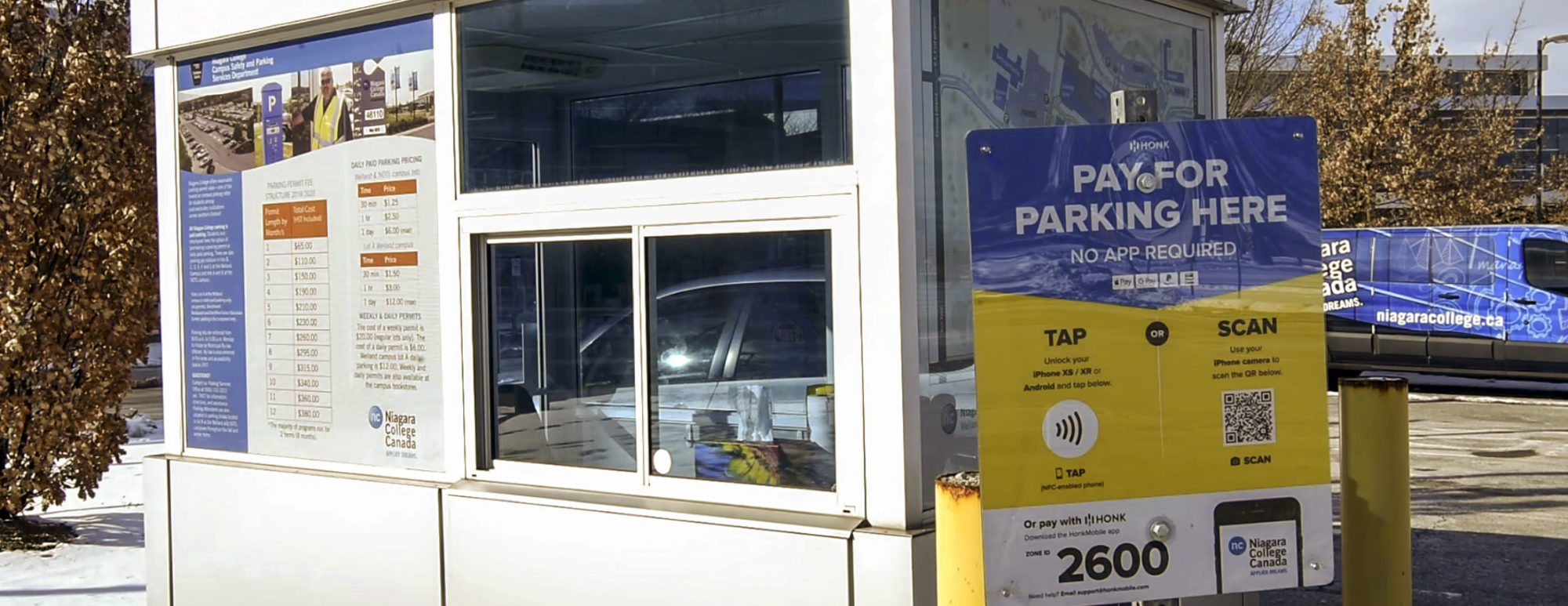An outdoor parking booth covered in signage about HonkMobile