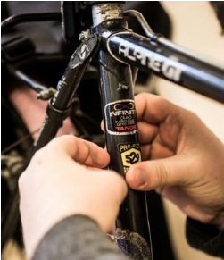 Image of 529 Garage Program sticker being applied to a bicycle