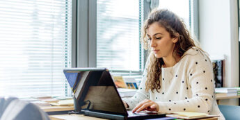 Female student works on a laptop