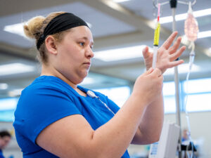 A nursing student preparing a needle.