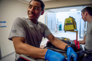 A paramedic student practicing scenarios in the paramedics lab.