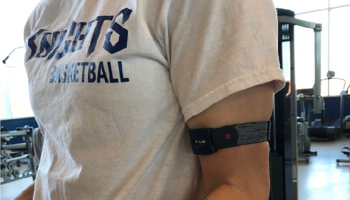 NC Student wearing new fitness technology around arm