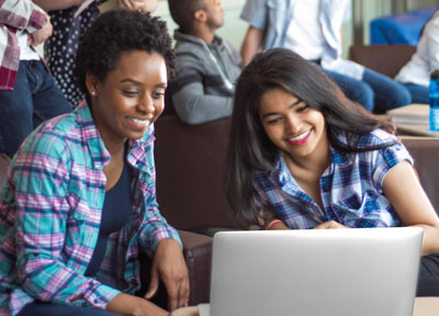 Two women working together at a laptop
