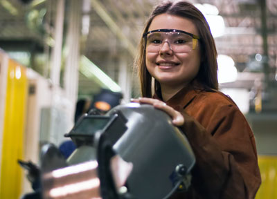 High school girl with welding helmet