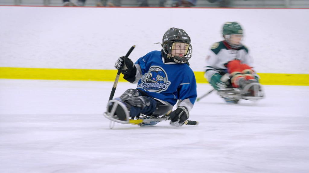 Two sledge hockey players