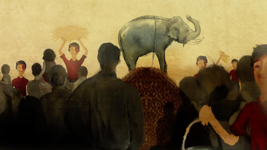 An elephant in the middle of a circus ring surrounded by people