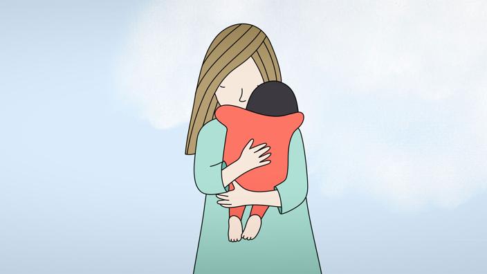A mother holding their child