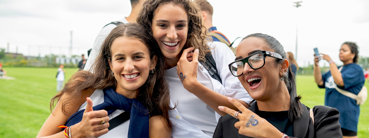 3 female students with NC Knights fake tattoos attend home game