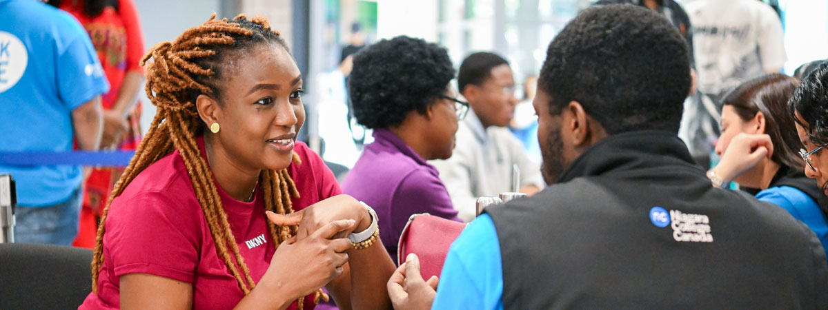 New student speaks with a student assistant during Orientation