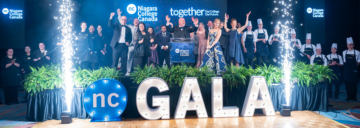 Entire Gala team and sponsors, including President Kennedy, gathered on stage while fireworks go off