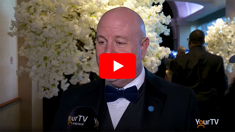 President Kennedy in a tux speaks during YourTV interview