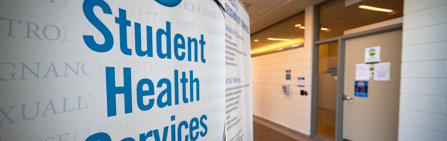 A view of the Student Health Services banner next to the entrance door