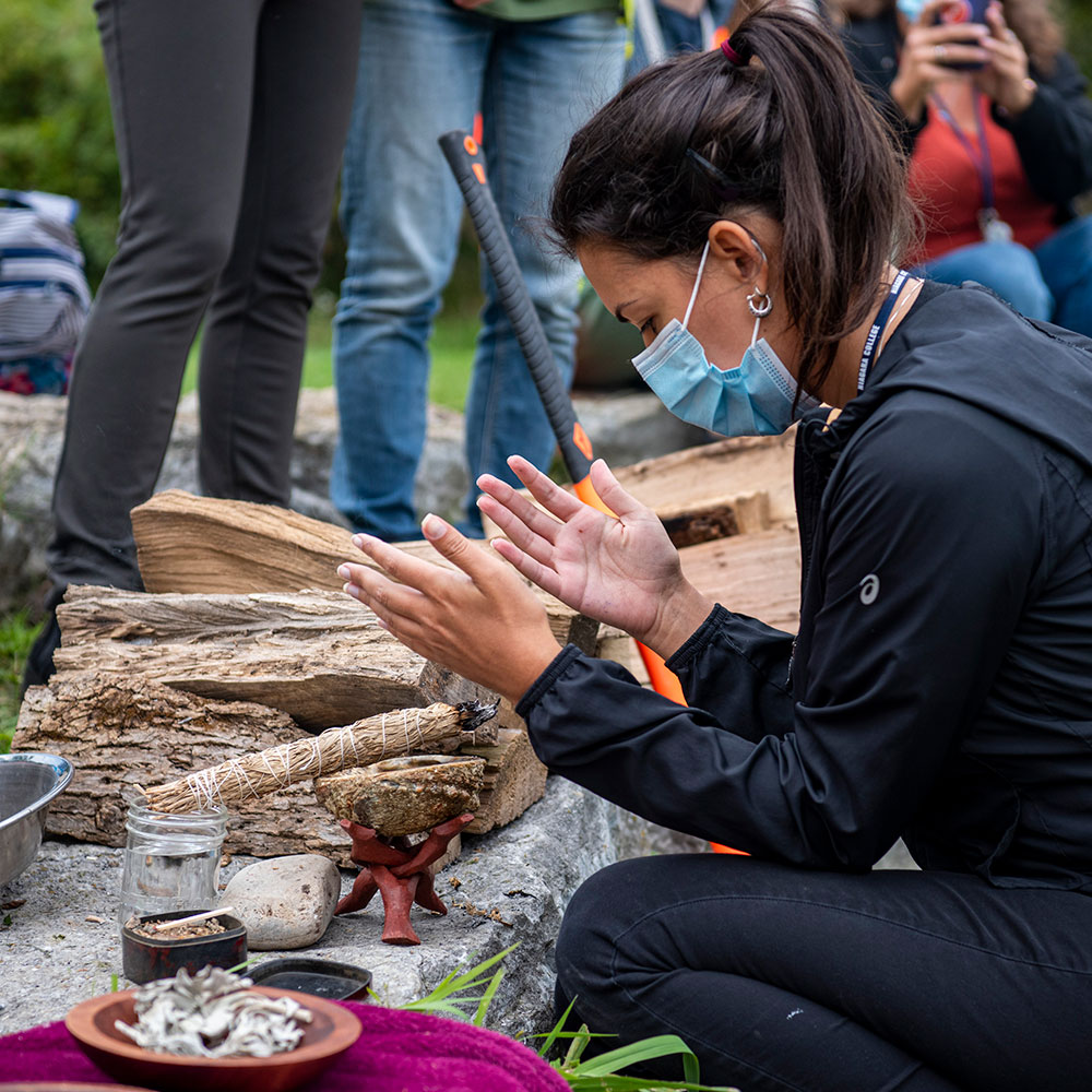 An indigenous student participating in smuding