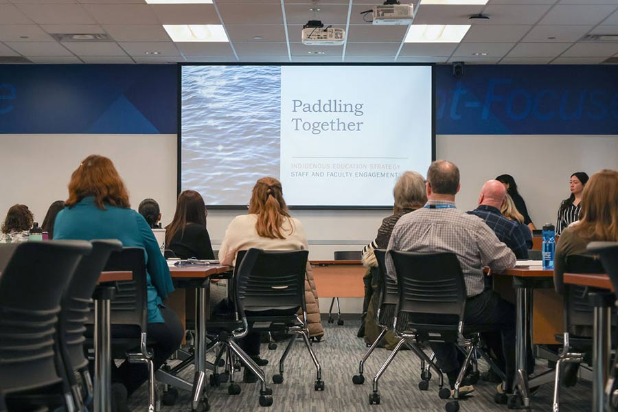 Paddling Together Seminar. People looking at projector screen.