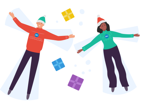 A man and woman wearing festive attire making snow angels