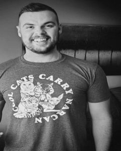 a headshot of Adam Coleman