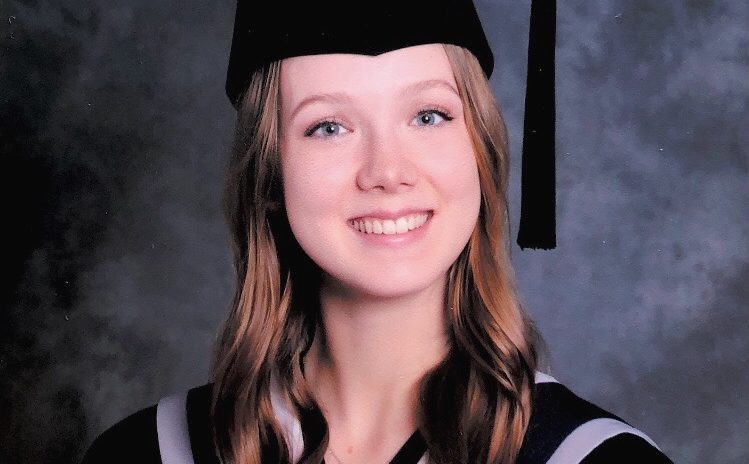 Photo of graduate wearing a cap and gown.