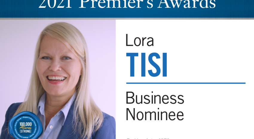 A headshot of a woman with long blonde hair wearing a blue collared shirt and suit jacket with the words 2021 Premier's Awards, Lora Tisi, Business Nominee, Fashion Arts, 1979
