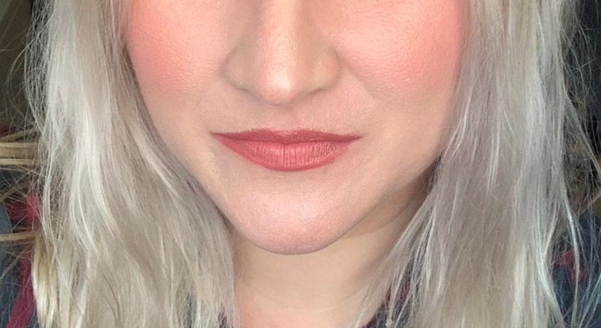 a head shot of a woman with long blonde hair