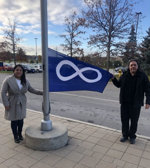 Metis-flag-raising-Ashley-Buck-and-Rick-Anderson-scaled-e1637078618643.jpg