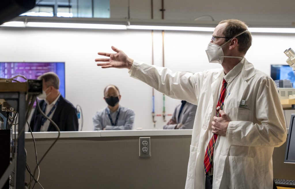 a professor wearing a white lab in a lab 