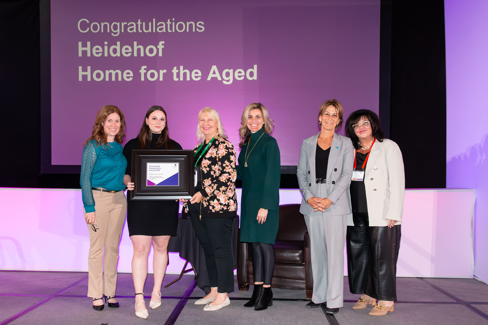 a group of people accept an award on a stage