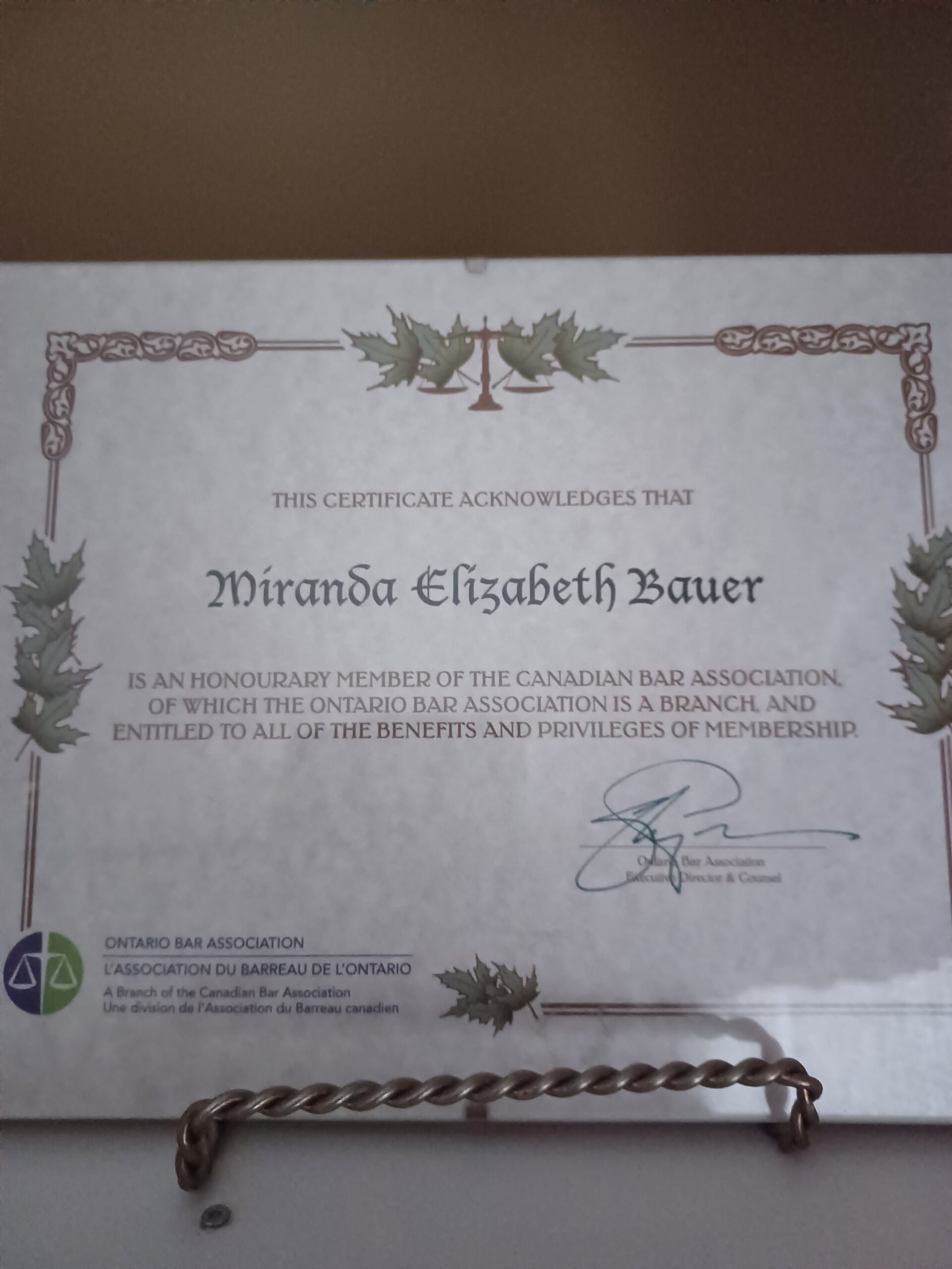 A certificate in a glass frame for Miranda Elizabeth Bauer from the the Canadian Bar Association