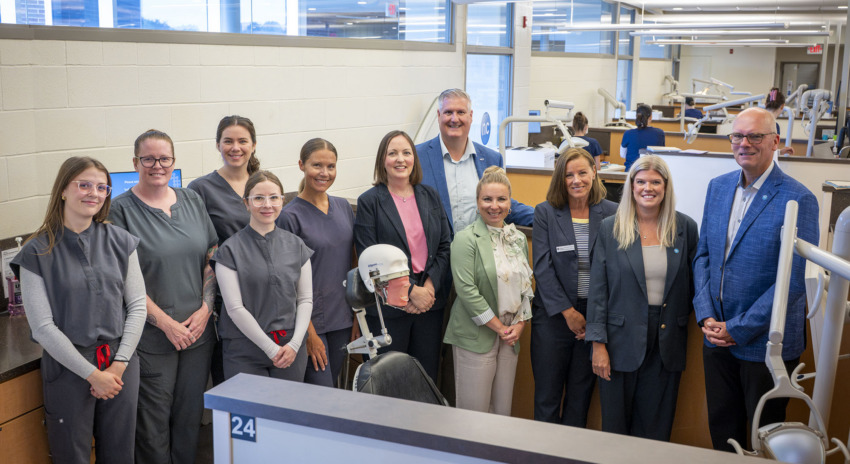 a group of people stand together in a dental clinic