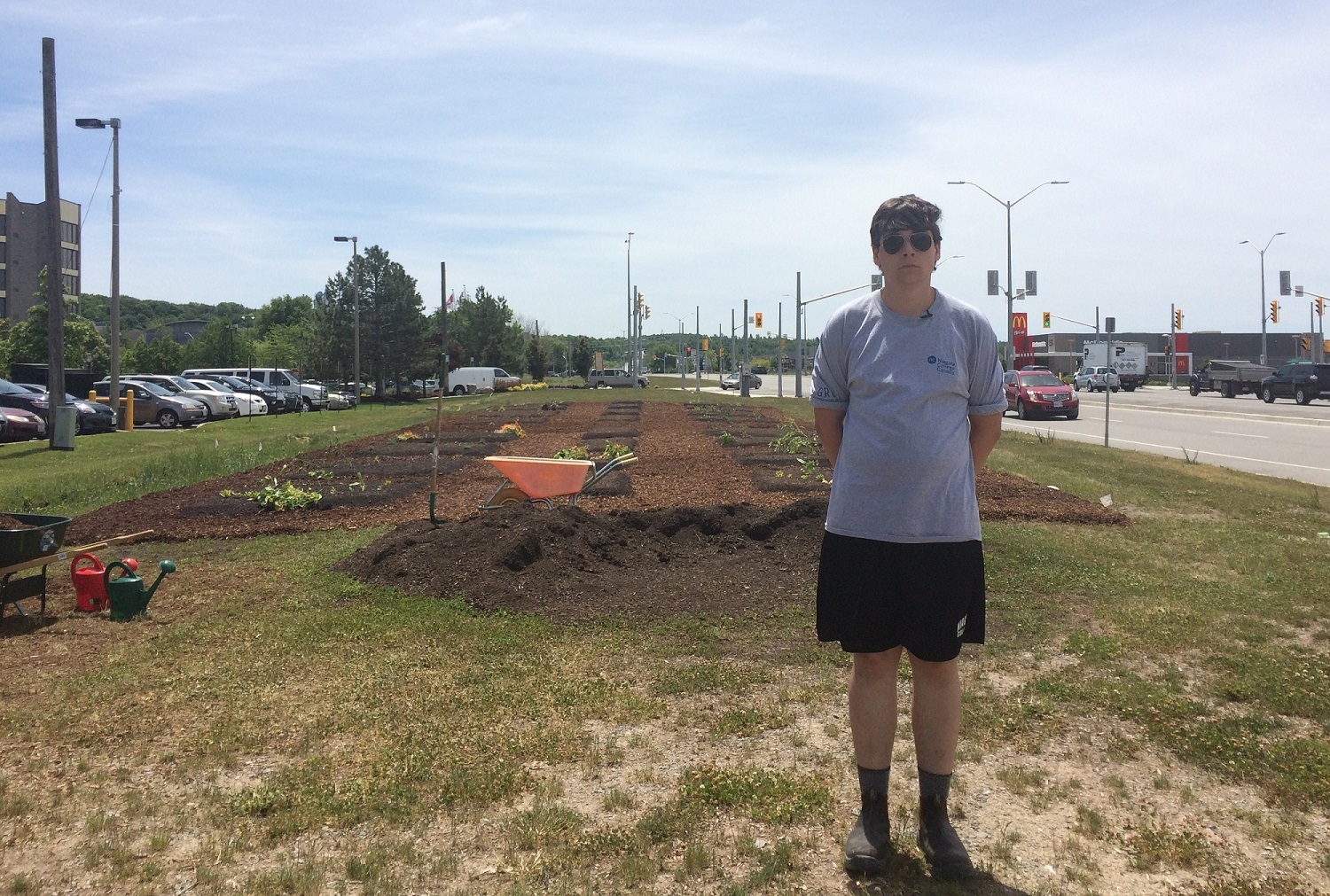 Summer student Mackenzie Haines gets ready to talk about his work building the White Oaks garden