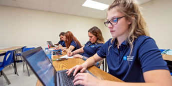 Student types on computer