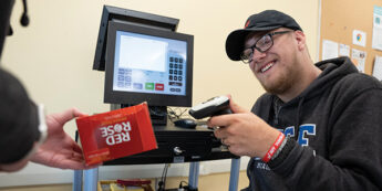 Student using a cashier simulation in a college classroom.