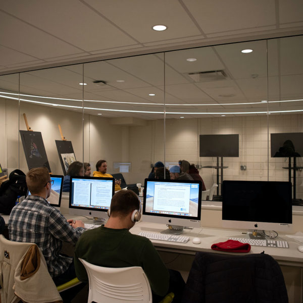 Mac lab with glass wall looking into drawing studio