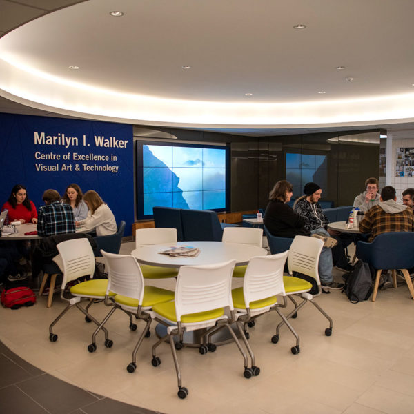 General area with tables and chairs, students sitting