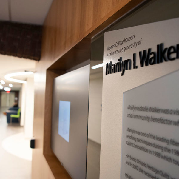 Hallway with wood paneling and plaque
