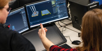 student working on a computer using a game development program