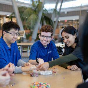 Students working together on beaded bracelets