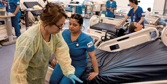 Two healthcare students work in a medical facility