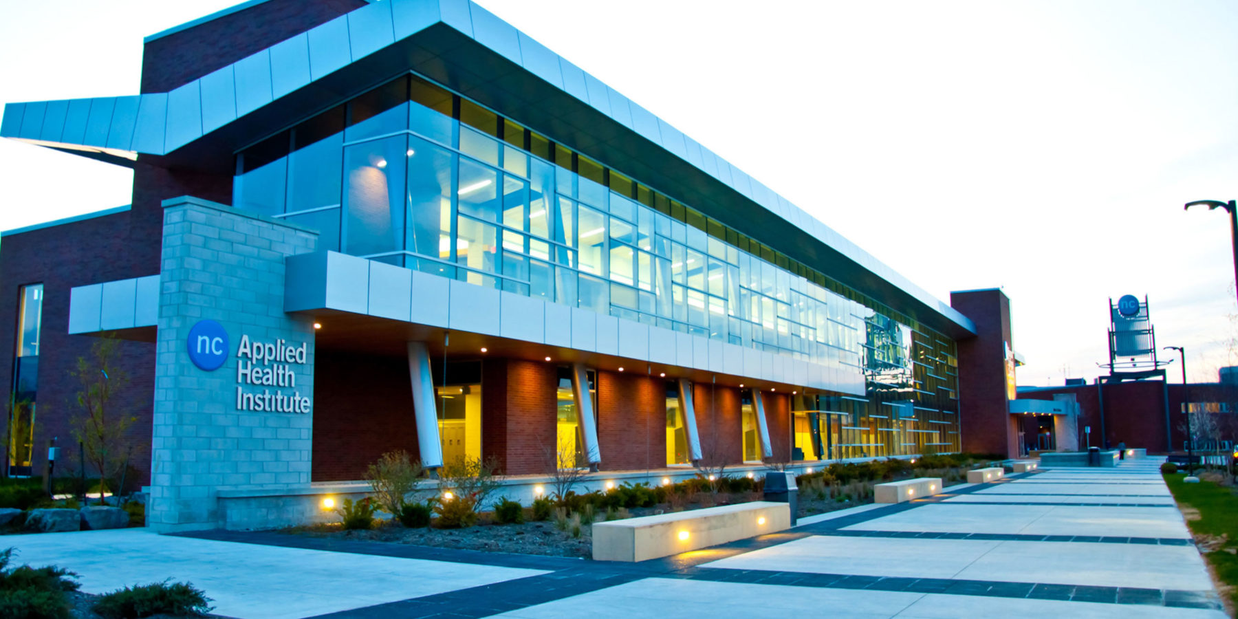 Applied Health Institute - modern building with glass and brick - at dusk
