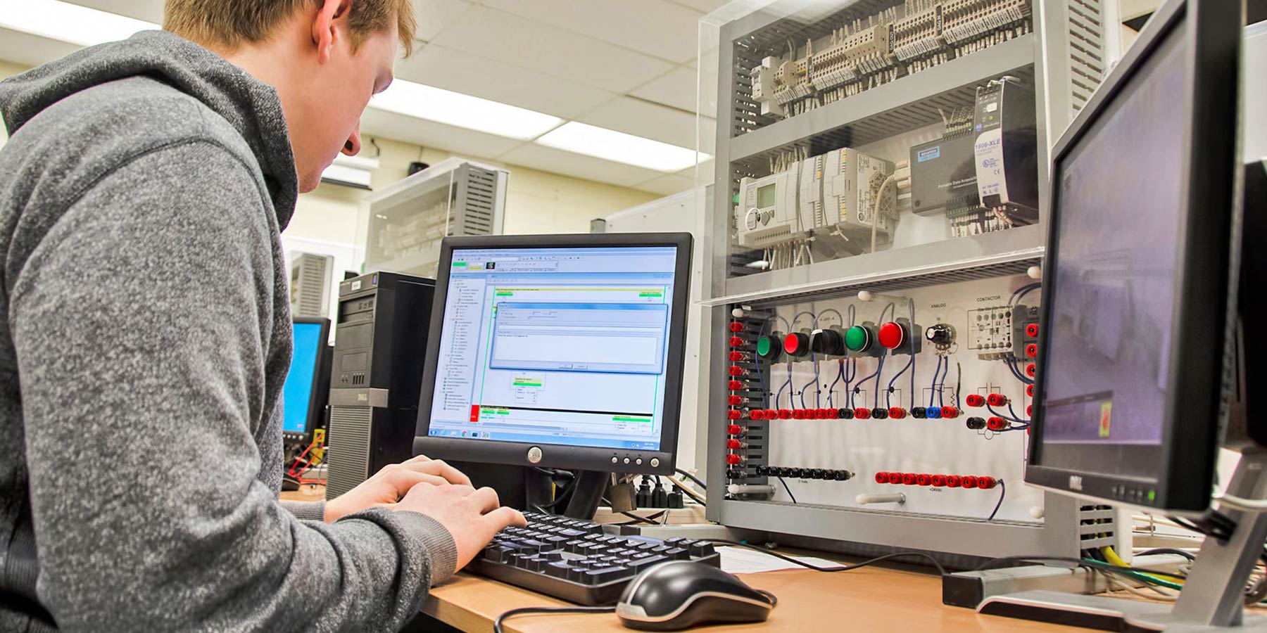 Student works on a computer attached to electrical interface