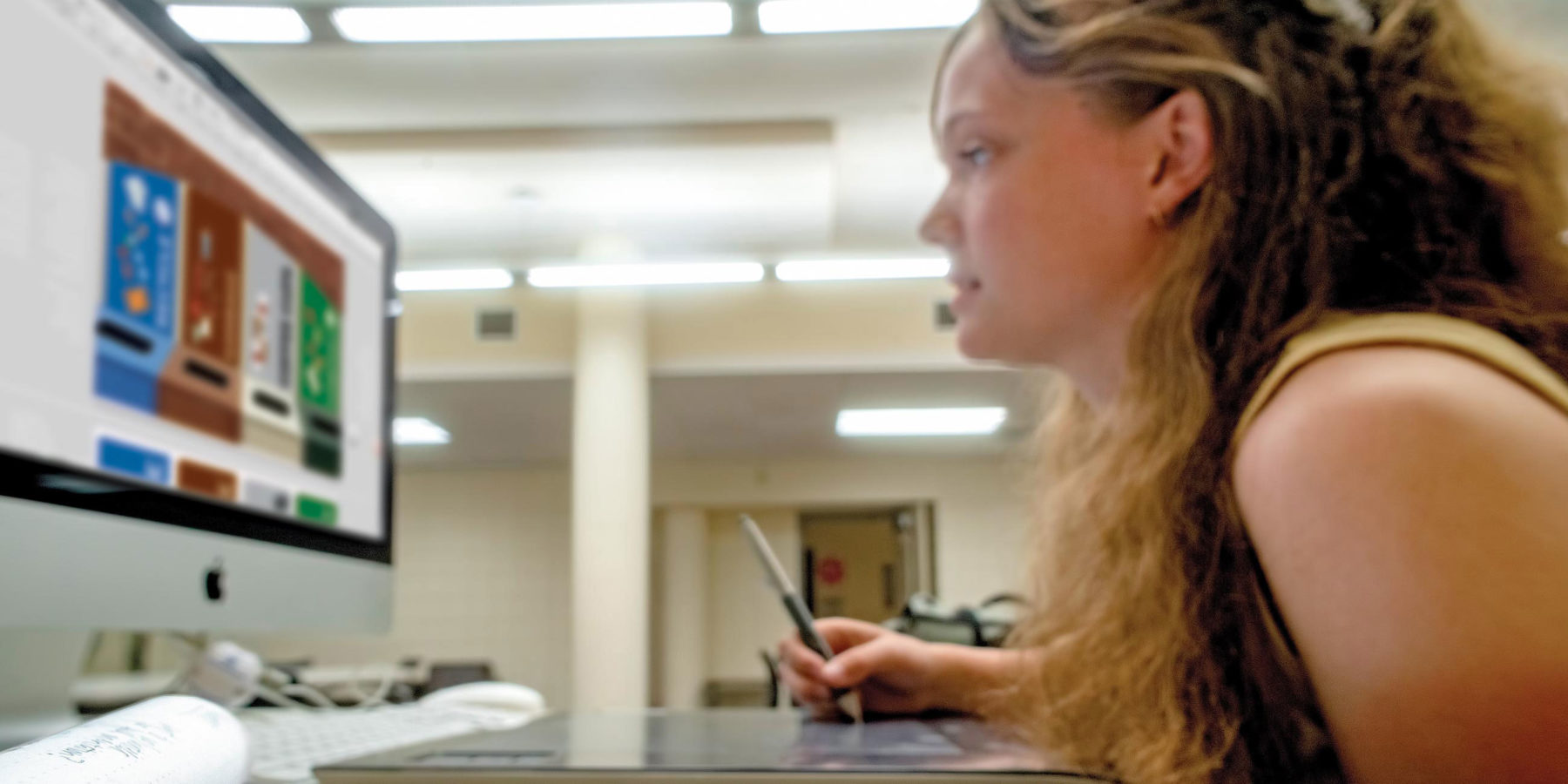 Female student works on a Mac computer