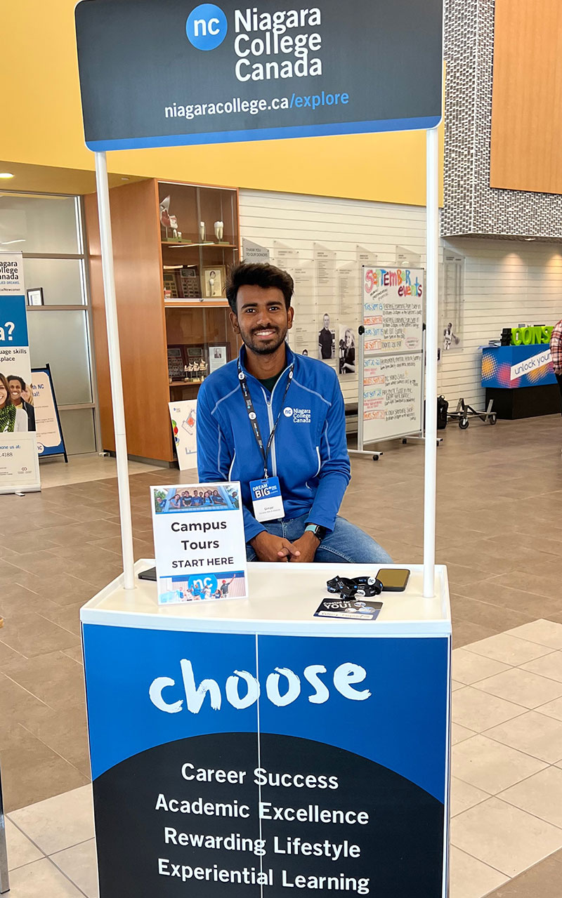 Tour guide standing at kiosk