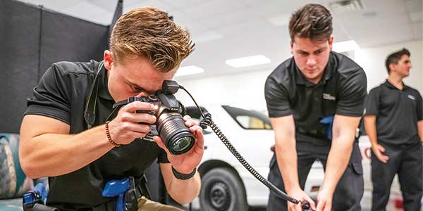 Advanced Law Enforcement and Investigation students taking photos of a simulated scene