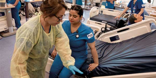 Two healthcare students work in a medical facility