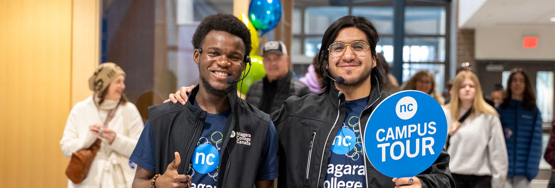 2 NC students smiling and excitedly giving thumbs up