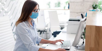Woman takes notes at computer