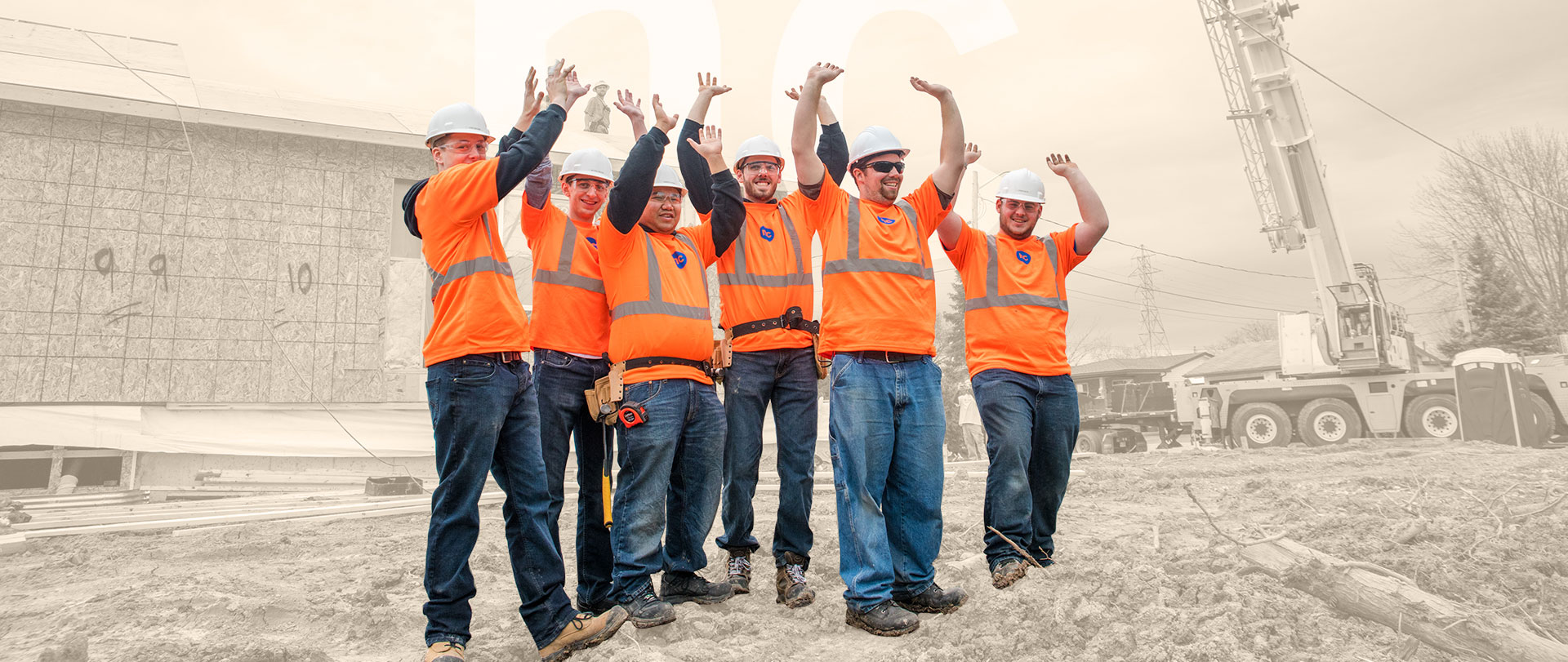 GRoup of construction students cheering together at a construction site