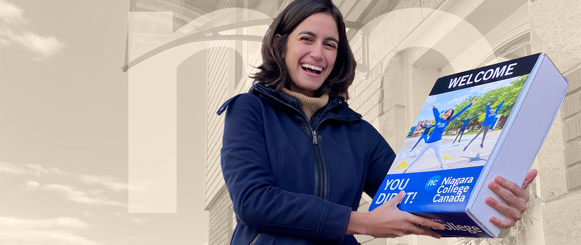 Young woman laughing as she delivers a NC surprise box to an applicant