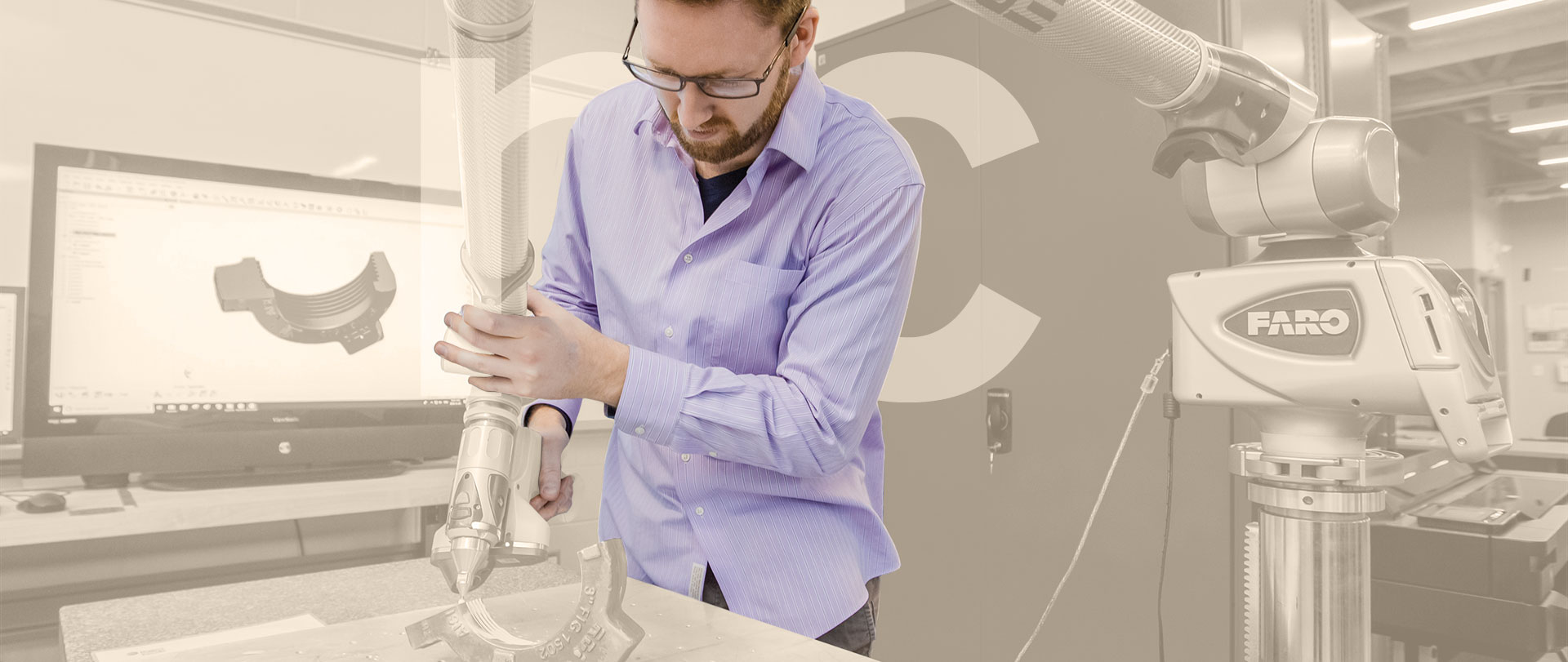 Student using a large piece of equipment to interact with a mechanical part