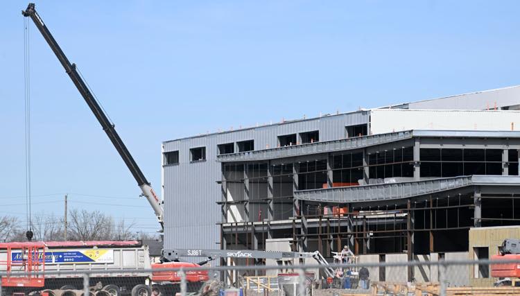A crane beside the 27,870-square-metre giga casting facility being built by Linamar in Welland, Ontario.